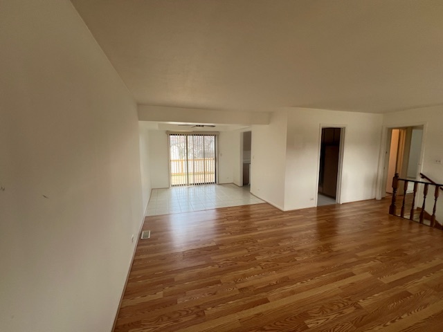 546 Yarmouth Road Elk Grove Village, IL 60007 - Photo 14 of 18 a view of an empty room with window and wooden floor