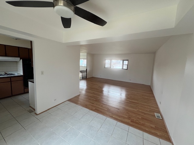 546 Yarmouth Road Elk Grove Village, IL 60007 - Photo 9 of 18 a view of an empty room and window and wooden floor
