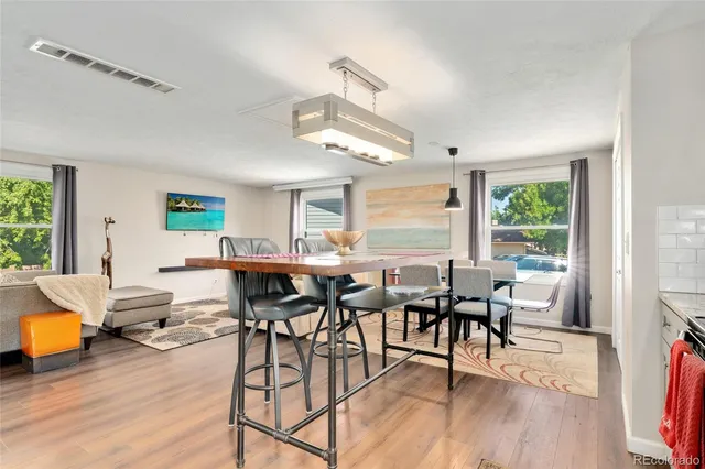 a view of a dining room with furniture window and wooden floor