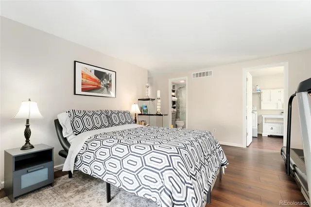 a bedroom with a large bed and a chandelier