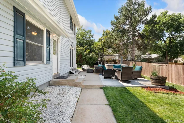 a view of a backyard with sitting area
