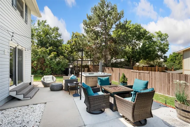 a view of a patio with couches table and chairs and potted plants