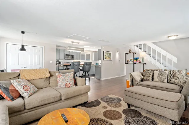 a living room with furniture and wooden floor
