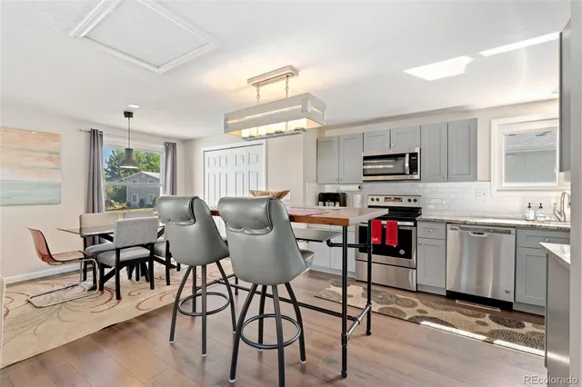 a living room with furniture a dining table and appliances