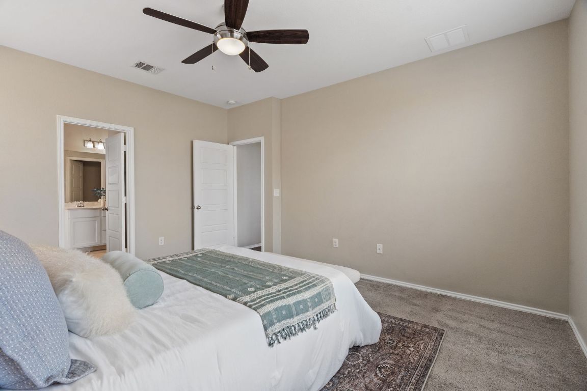 7504 Groundhog Way Austin, TX 78744 - Photo 11 of 22 Enjoy the convenience and privacy of a spacious primary bedroom and ensuite bathroom.