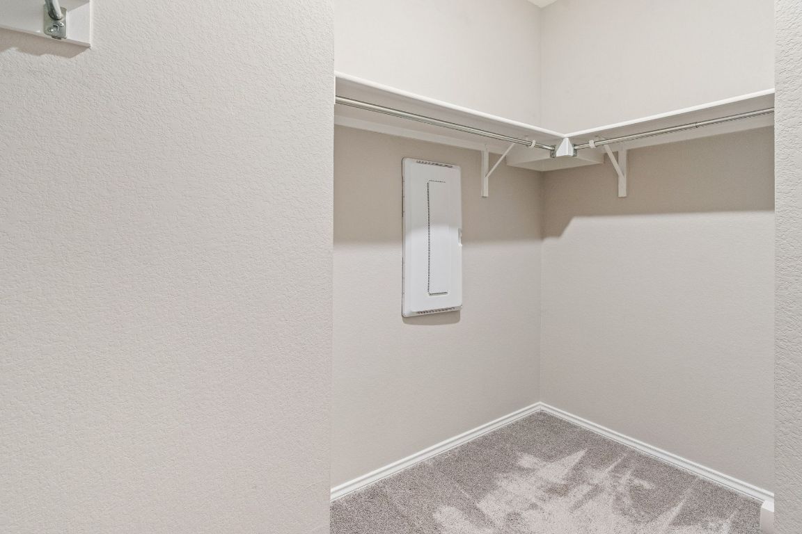 7504 Groundhog Way Austin, TX 78744 - Photo 14 of 22 The primary closet offers plenty of storage, located off the primary bathroom.