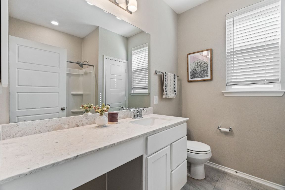 7504 Groundhog Way Austin, TX 78744 - Photo 15 of 22 The secondary bathroom has tons of counter space and a shower/tub combo.