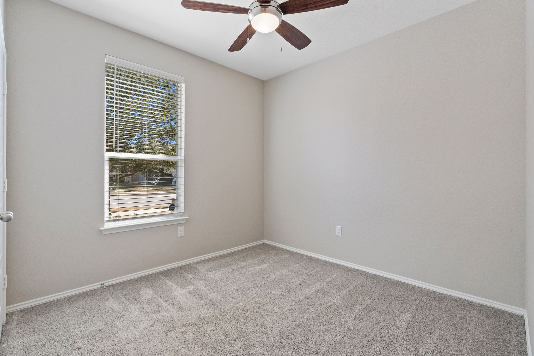 7504 Groundhog Way Austin, TX 78744 - Photo 16 of 22 an empty room with a window and a fan
