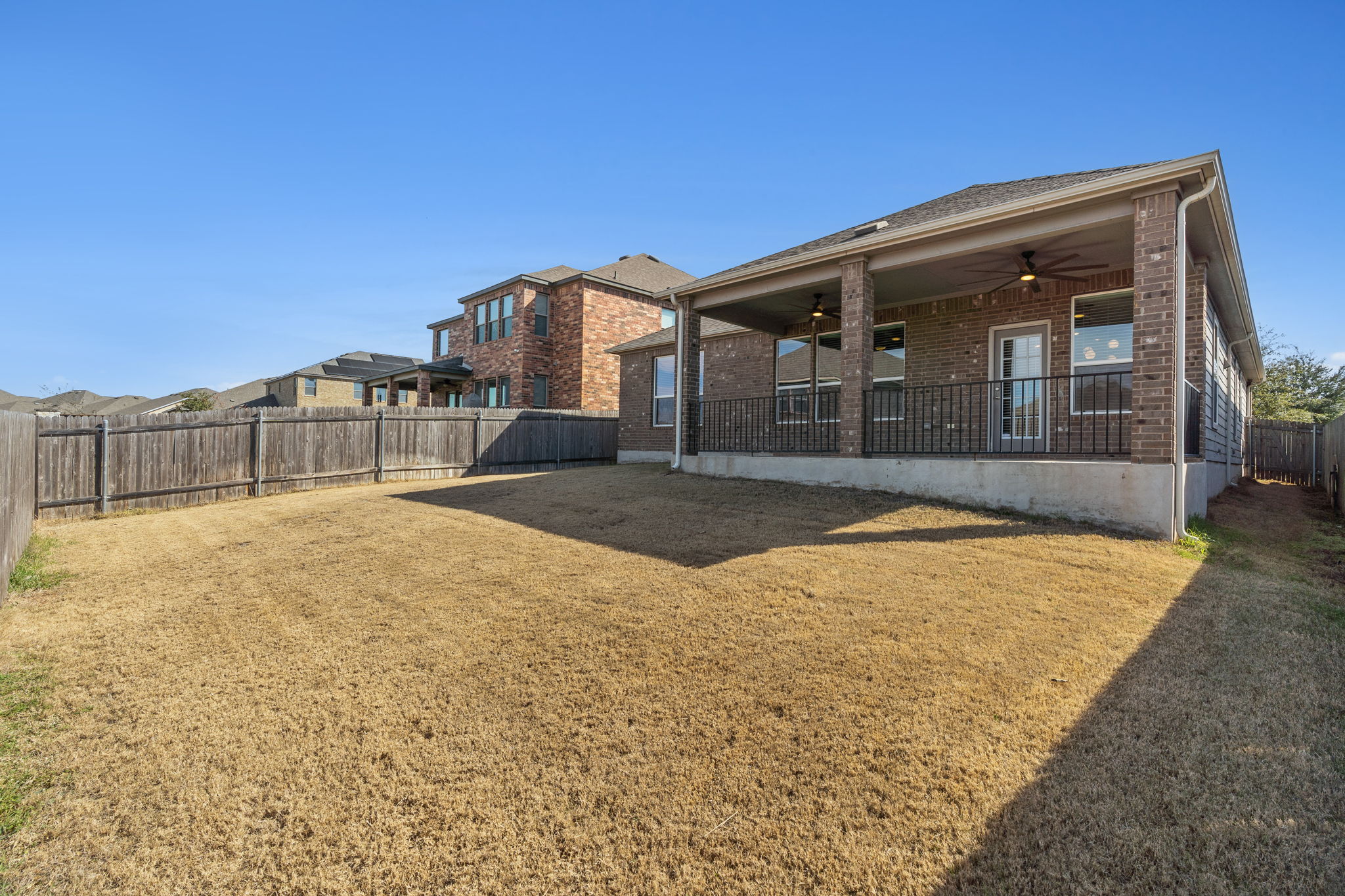 7504 Groundhog Way Austin, TX 78744 - Photo 20 of 22 a front view of a house with a yard