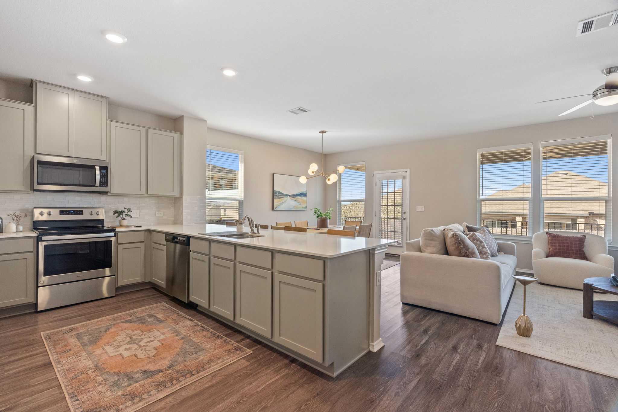 7504 Groundhog Way Austin, TX 78744 - Photo 2 of 22 a kitchen with sink a microwave and cabinets