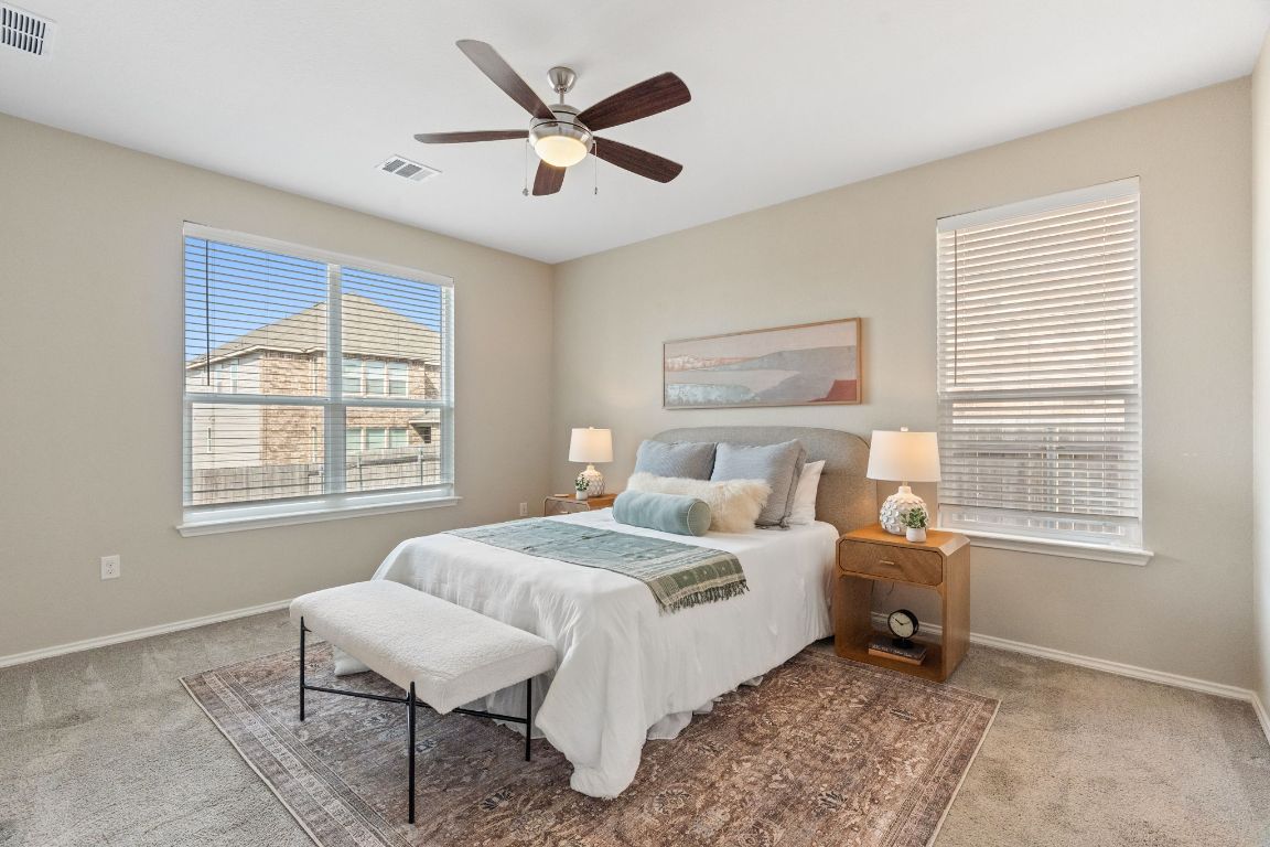7504 Groundhog Way Austin, TX 78744 - Photo 10 of 22 The large primary bedroom is a perfect retreat after a full day and also a peaceful start to every morning.
