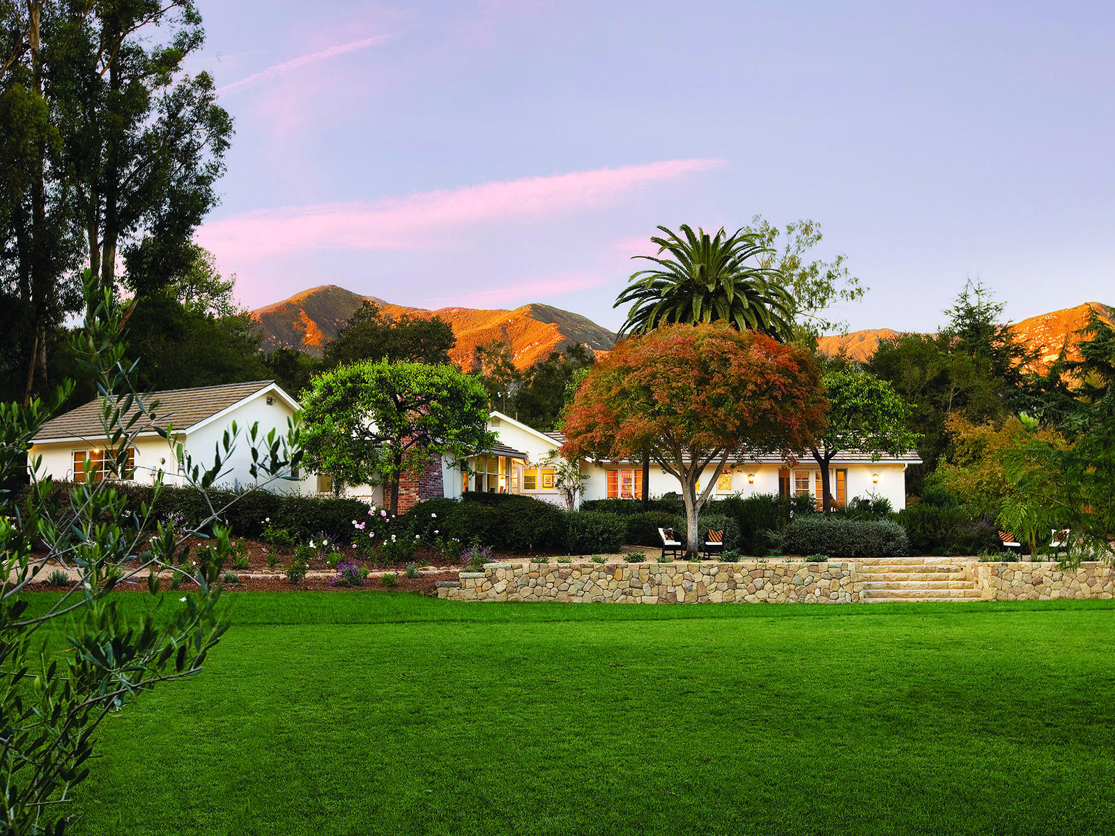 1381 East Valley Road Montecito, CA 93108 - Photo 2 of 13 a front view of a house with a garden