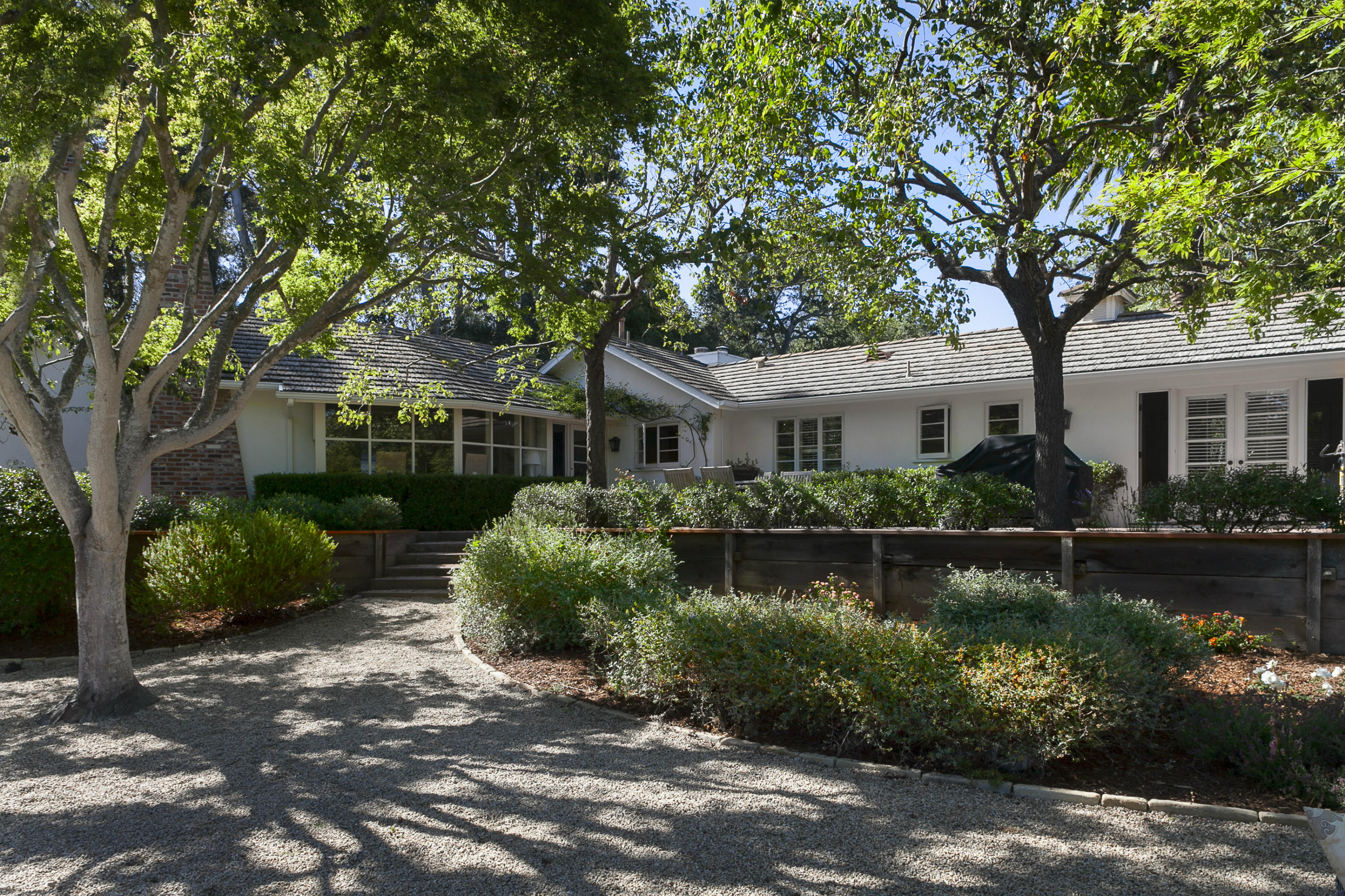 1381 East Valley Road Montecito, CA 93108 - Photo 3 of 13 a front view of a house with a garden