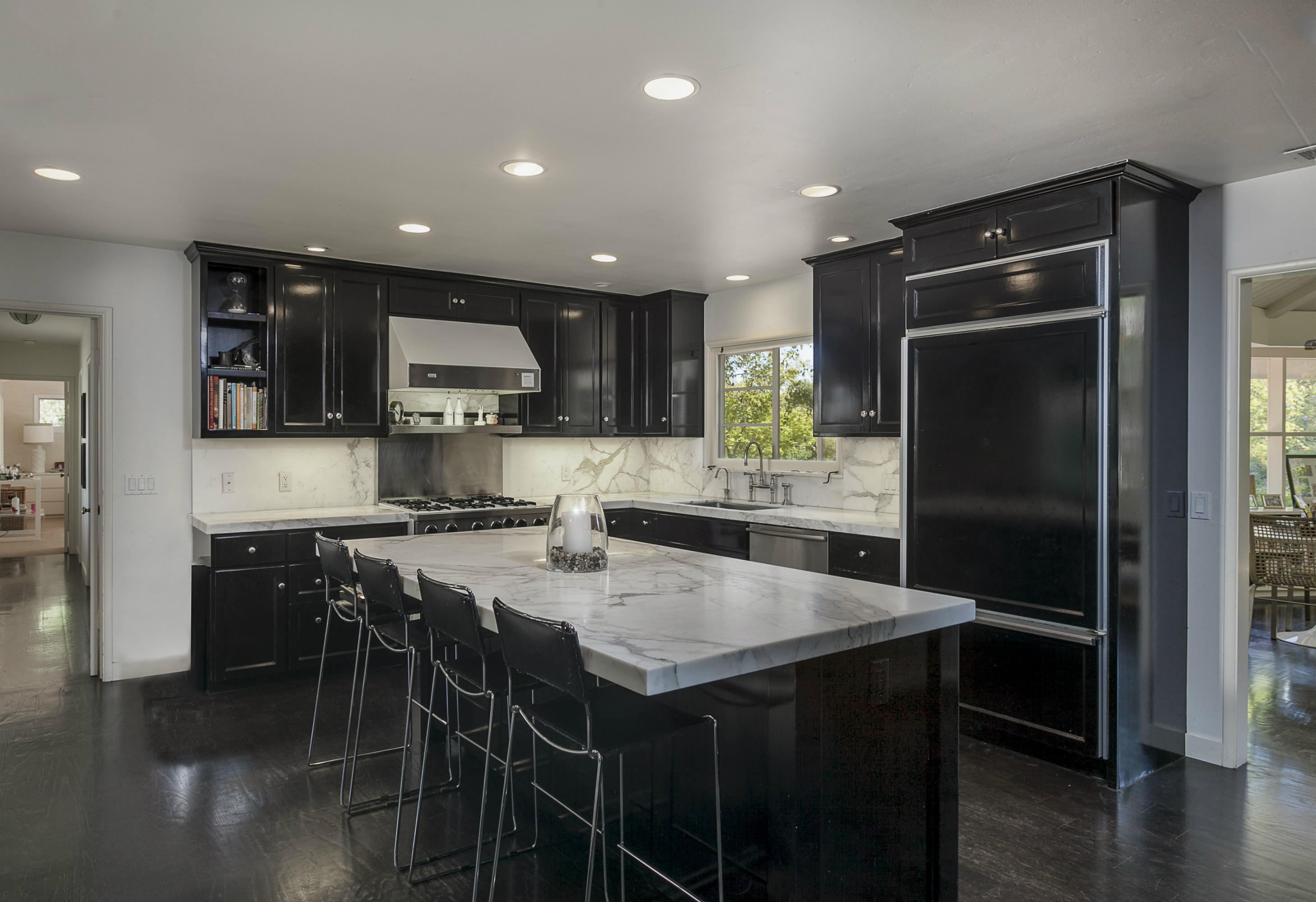 1381 East Valley Road Montecito, CA 93108 - Photo 9 of 13 a kitchen with stainless steel appliances granite countertop a refrigerator a sink a stove a dining table and chairs