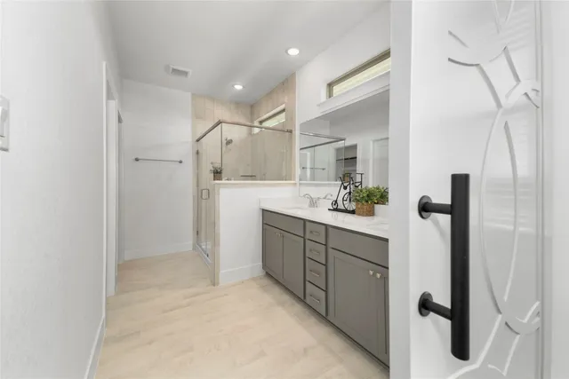 a bathroom with a sink vanity and a mirror