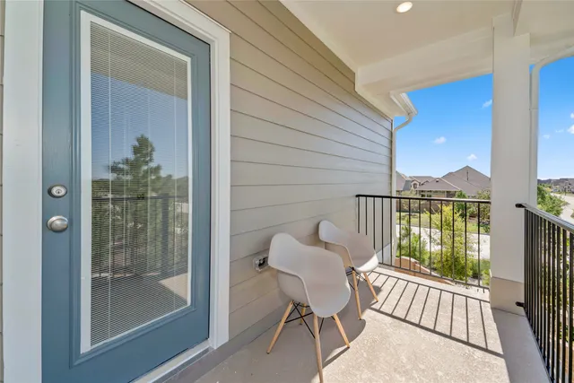 a view of a balcony with furniture