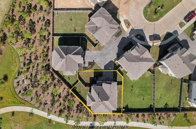 an aerial view of a house with a swimming pool