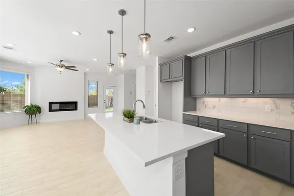 a kitchen with kitchen island a sink stainless steel appliances and cabinets