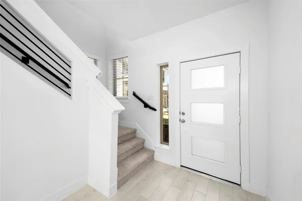 an entryway with a white walls
