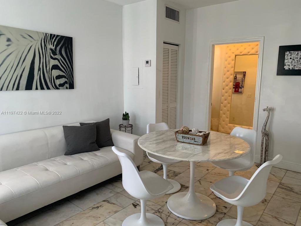 Flamingo-Lummus Miami Beach, FL 33139 - Photo 2 of 8 a living room with furniture and a table