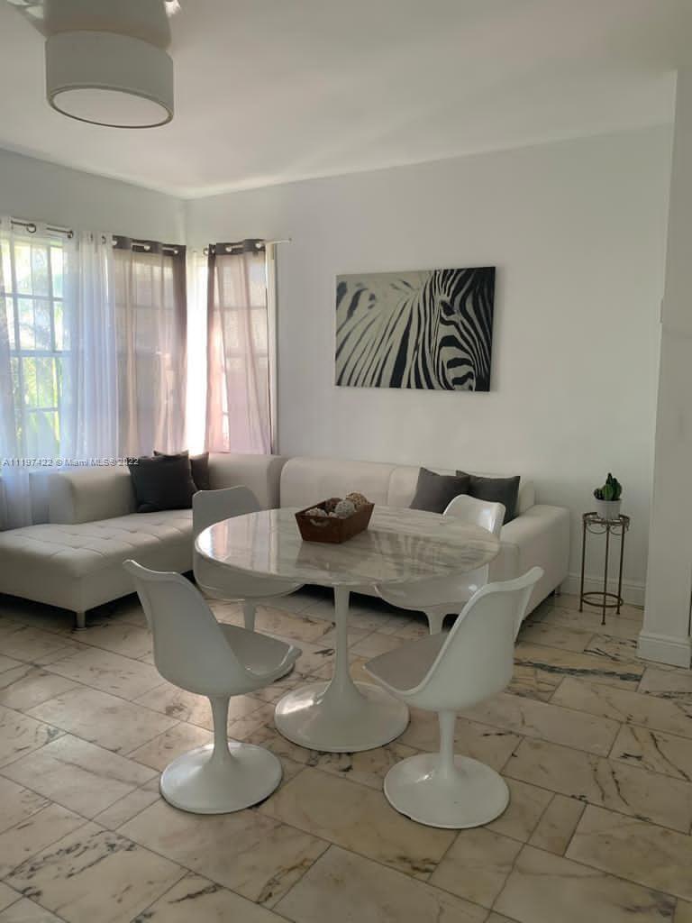 Flamingo-Lummus Miami Beach, FL 33139 - Photo 5 of 8 a living room with furniture and a large window