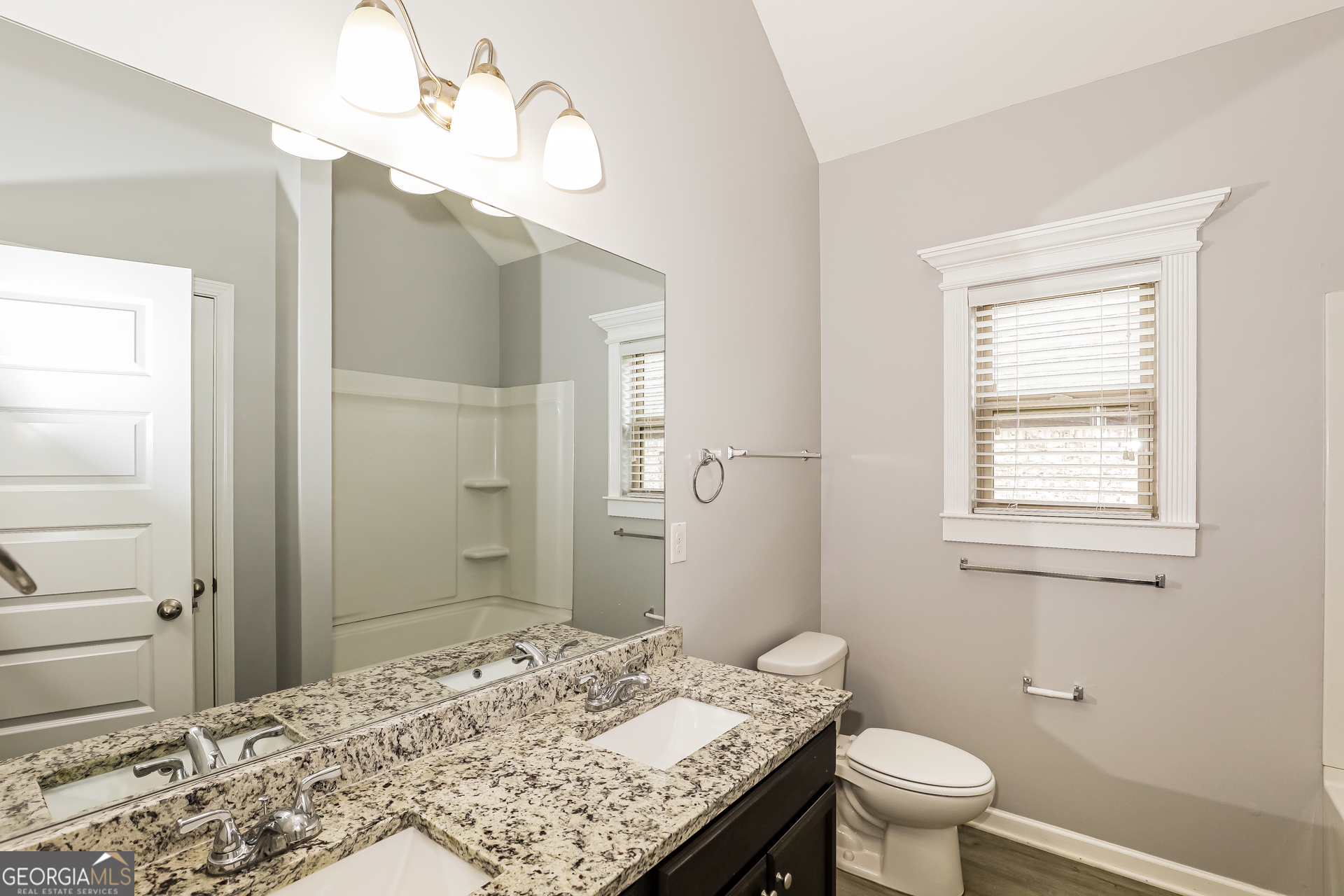3216 Alhambra Circle Hampton, GA 30228 - Photo 19 of 21 a bathroom with a granite countertop sink toilet and shower