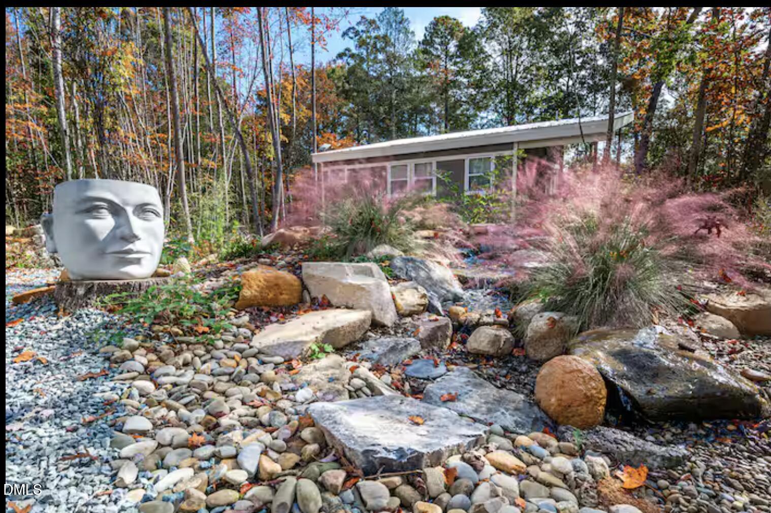 286 Stone Wall Road Pittsboro, NC 27312 - Photo 29 of 71 a view of a backyard with plants and outdoor seating