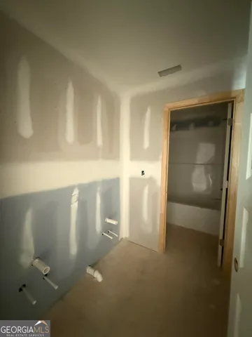 a view of a brick house with potted plants