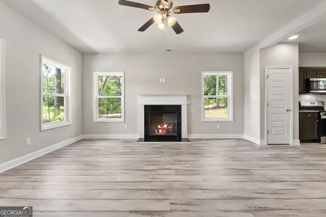 a kitchen with kitchen island granite countertop stainless steel appliances a sink stove refrigerator and cabinets