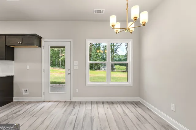 a bathroom with a granite countertop sink a mirror and a shower
