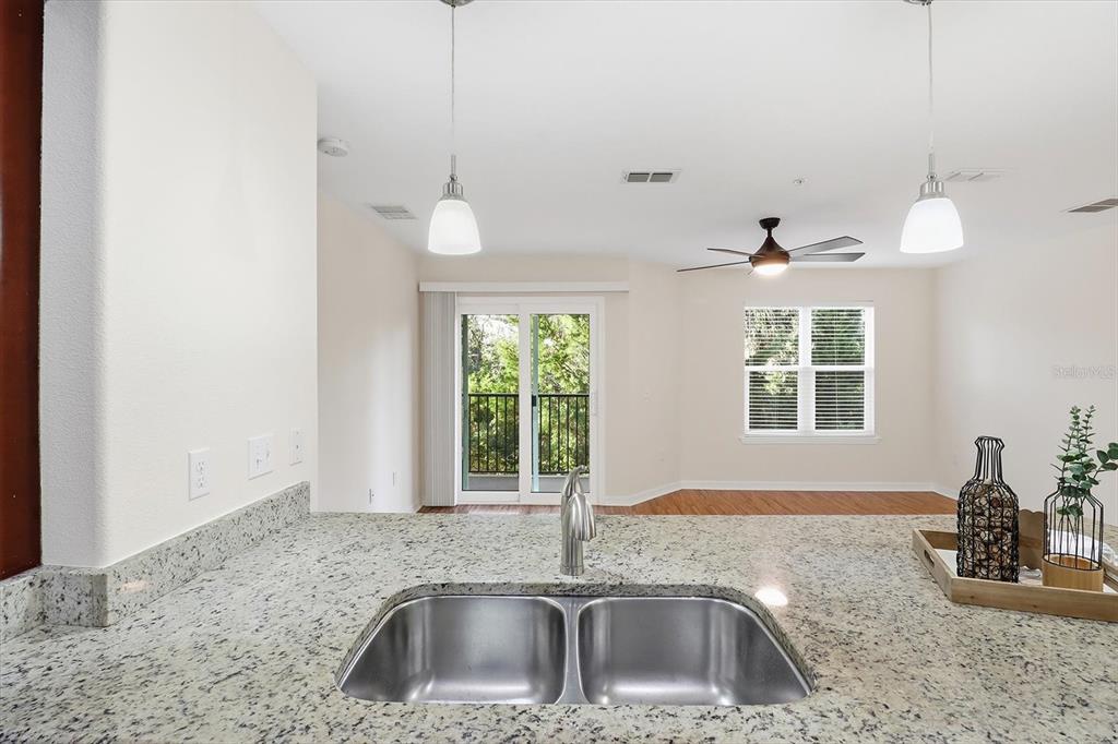 5041 Royal Palms Way, Unit 202 New Port Richey, FL 34652 - Photo 13 of 41 a kitchen with a sink and a window