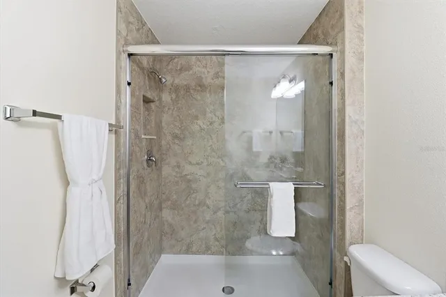 a view of a lake with a yard and palm trees