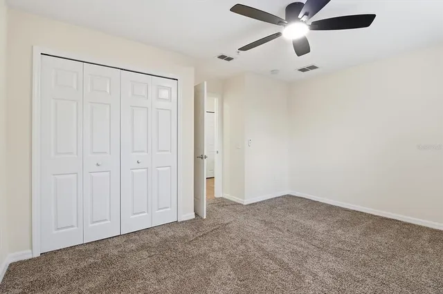 a view of a hallway with wooden floor and entryway