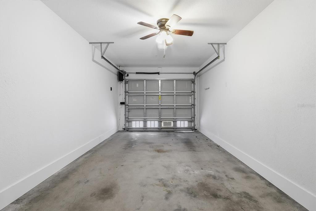 5041 Royal Palms Way, Unit 202 New Port Richey, FL 34652 - Photo 28 of 41 an empty room with windows and ceiling fan