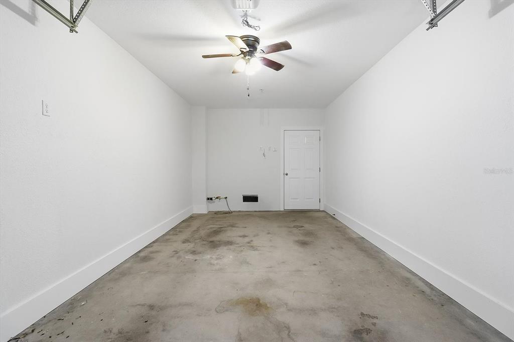 5041 Royal Palms Way, Unit 202 New Port Richey, FL 34652 - Photo 29 of 41 an empty room with a ceiling fan and a window