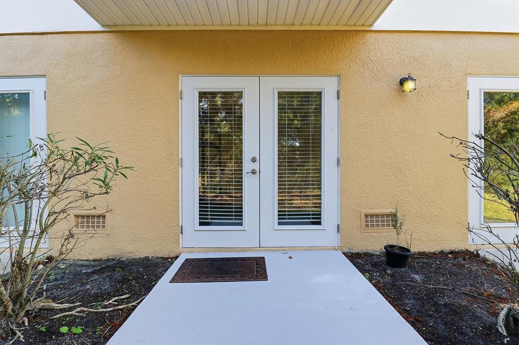 5041 Royal Palms Way, Unit 202 New Port Richey, FL 34652 - Photo 32 of 41 a bedroom with a bed and a window