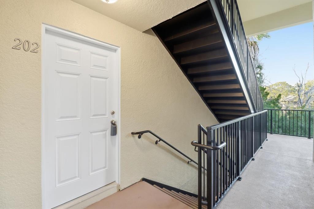 5041 Royal Palms Way, Unit 202 New Port Richey, FL 34652 - Photo 39 of 41 a view of a hallway with wooden floor and entryway