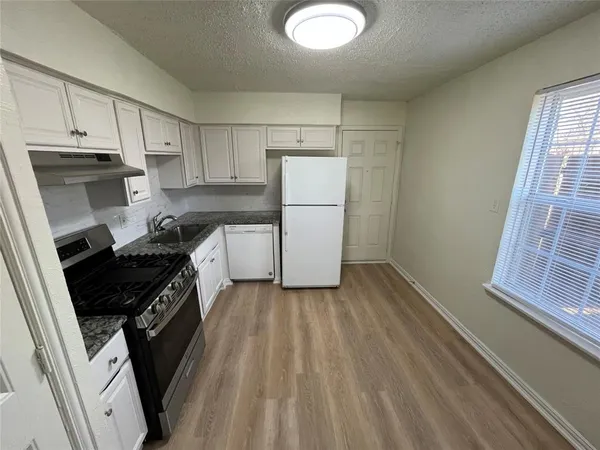 a stove top oven sitting inside of a kitchen
