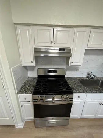a kitchen with a sink and cabinets