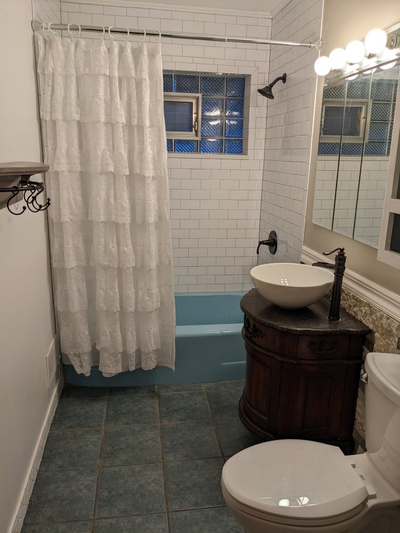 1009 Whitfield Road Northbrook, IL 60062 - Photo 12 of 25 a white toilet sitting next to a bathroom sink