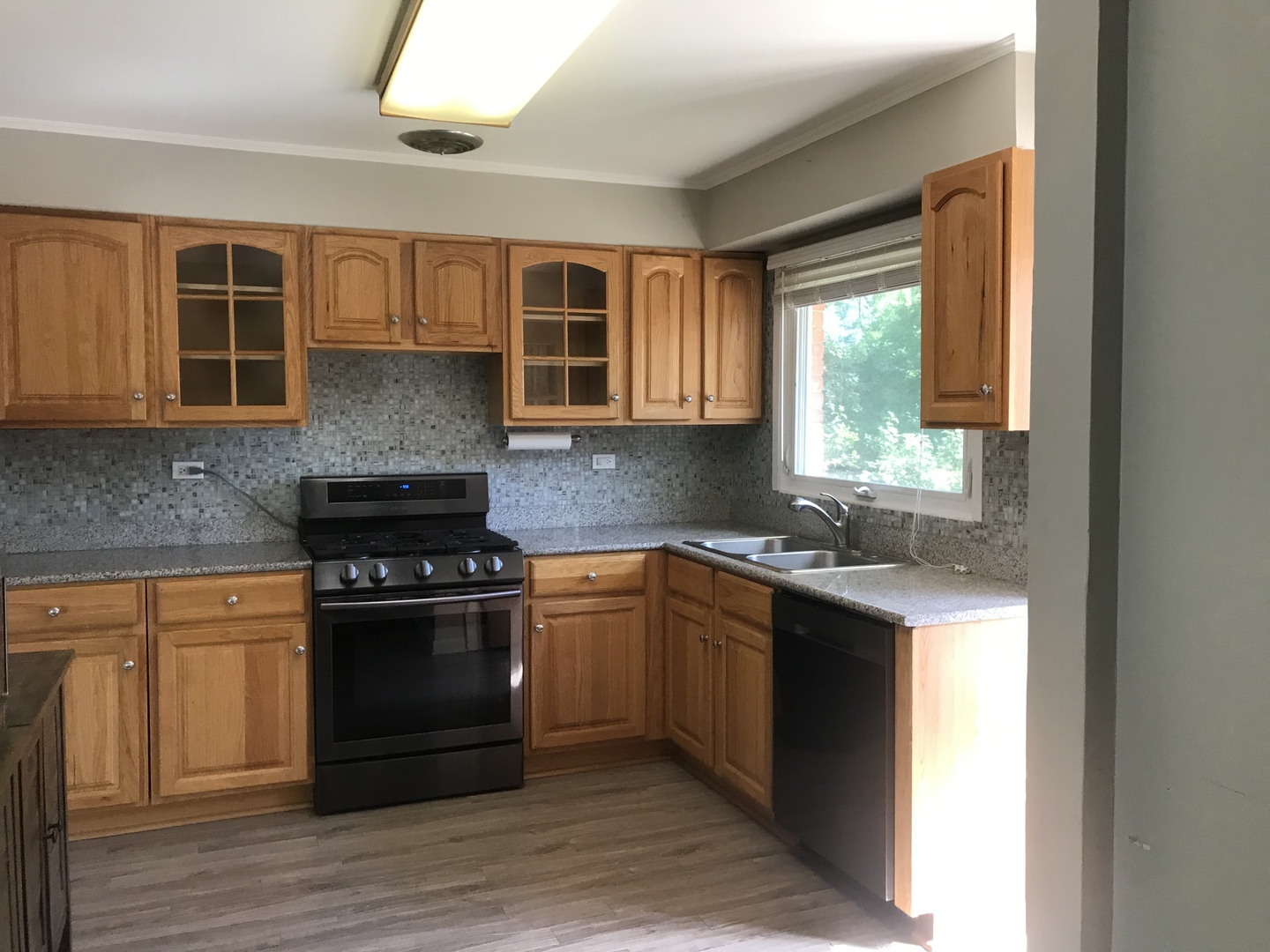 1009 Whitfield Road Northbrook, IL 60062 - Photo 7 of 25 a kitchen with stainless steel appliances granite countertop a stove a sink and a microwave
