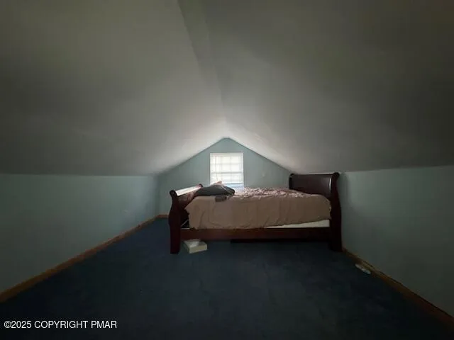 a bedroom with a bed lamp and a table
