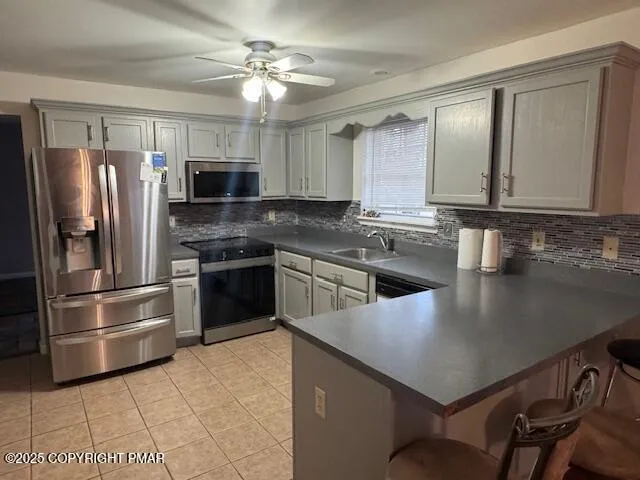 a kitchen with a refrigerator a sink and cabinets