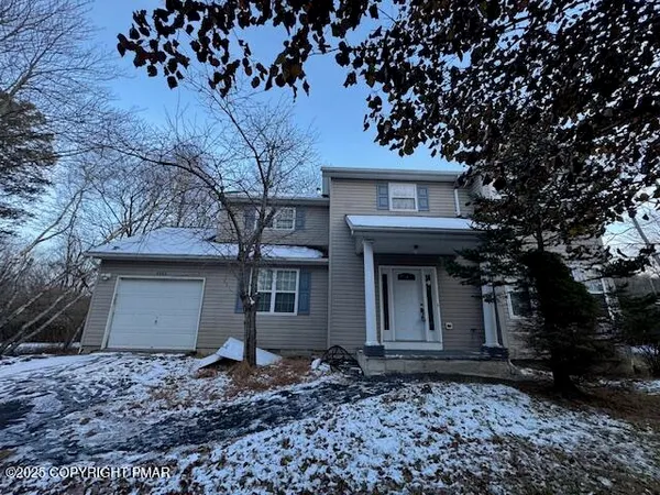 a house that has a tree in front of it