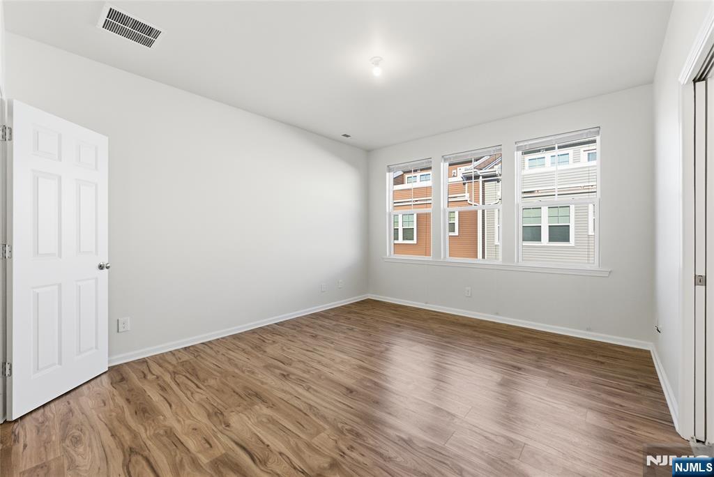 6 Bond Street North Brunswick, NJ 08902 - Photo 22 of 34 a view of empty room with wooden floor and fan