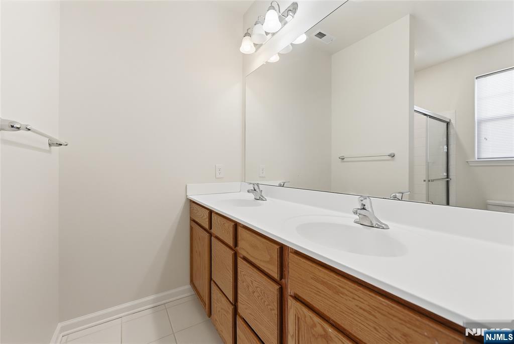 6 Bond Street North Brunswick, NJ 08902 - Photo 24 of 34 a bathroom with a sink a vanity and a mirror