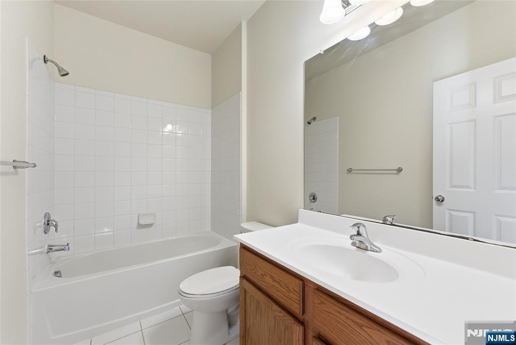 6 Bond Street North Brunswick, NJ 08902 - Photo 27 of 34 a bathroom with a sink a toilet and shower