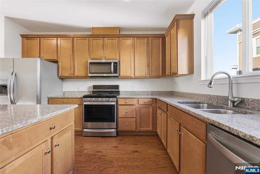 6 Bond Street North Brunswick, NJ 08902 - Photo 10 of 34 a kitchen with granite countertop a stove a sink and a microwave