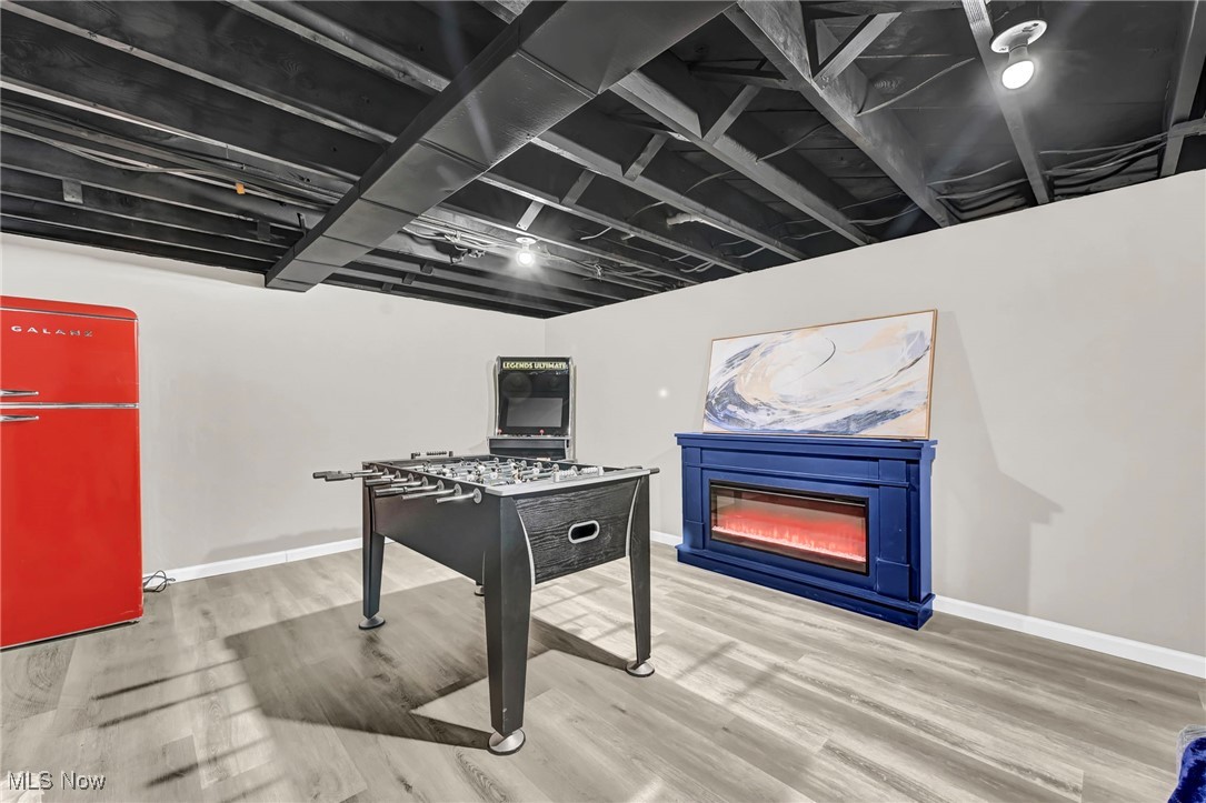 1731 Berger Road Akron, OH 44312 - Photo 30 of 37 Recreation room with an electric fireplace and wood finished floors