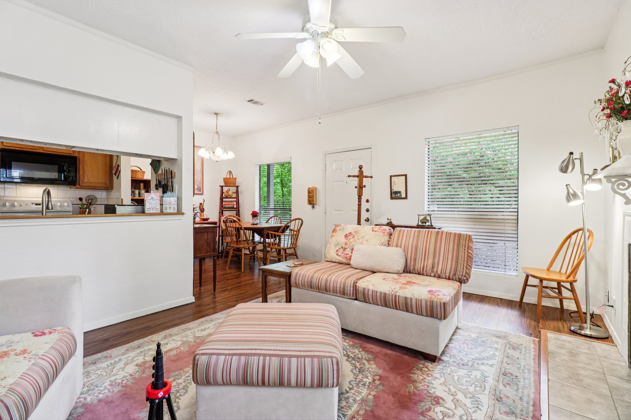 802 South 1st Street, Unit 121 Austin, TX 78704 - Photo 2 of 12 a living room with furniture and a dining table with kitchen appliances